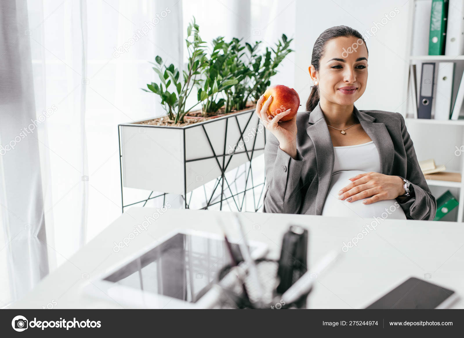 Pregnant Woman Holding Apple Looking Away Smiling While Sitting Table ...