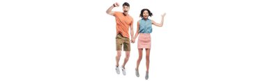 panoramic shot of happy man and woman holding hands and jumping while showing triumph gestures isolated on white clipart