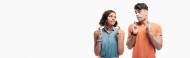 panoramic shot of young and woman holding crossed fingers and looking at each other  isolated on white clipart