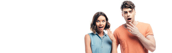 panoramic shot of shocked man and woman looking at camera isolated on white