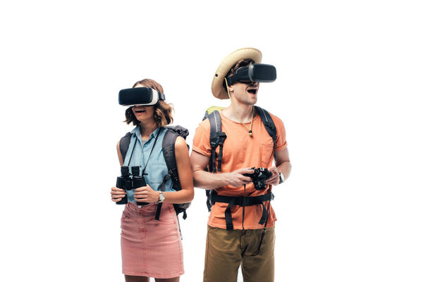 два молодых туриста с биноклем и цифровой камерой с использованием наушников виртуальной реальности, изолированных на белом
