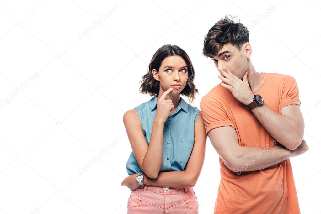handsome young man whispering to thoughtful woman and looking at camera isolated on white