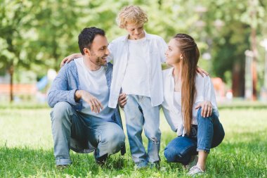 gündüz parkta kucaklayan rahat giysiler içinde mutlu aile