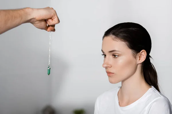 Cropped View Hypnotist Standing Woman Holding Green Stone Her Face — Stock Photo, Image