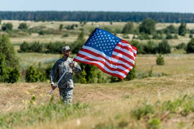 üniforma lı ve şapkalı ve amerikan bayrağı tutan yakışıklı askeri adamın seçici odak 