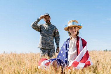 asker yakınında Amerikan bayrağı ile duran mutlu çocuk seçici odak 