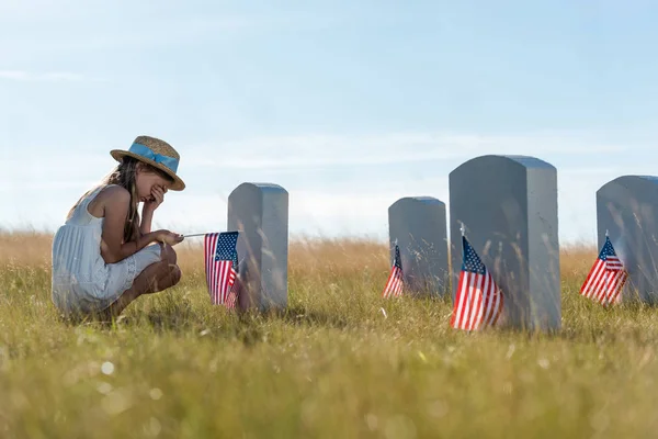 Selective Focus Child Covering Face While Sitting Headstones American Flags — Stock Photo, Image