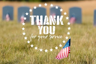 selective focus of american flag with stars and stripes near gravestones with thank you for your service illustration clipart