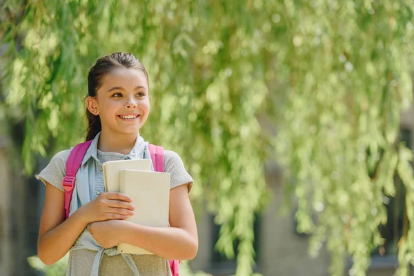 Onnellinen Koulutyttö Katselee Pois Seistessään Puistossa Pitää Kirjoja — kuvapankkivalokuva