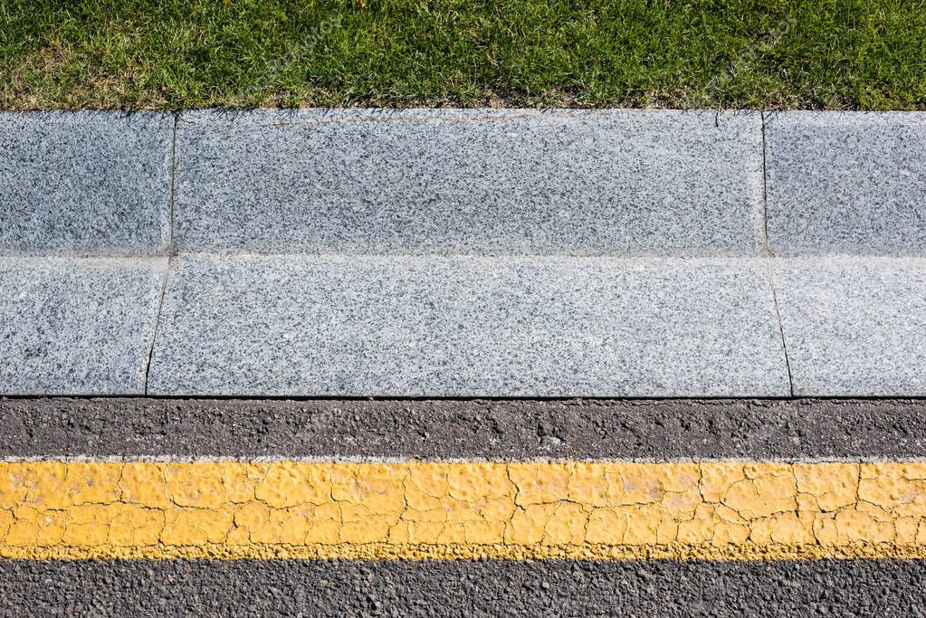 Close up of border near road and green grass