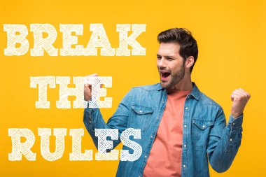 happy handsome man showing yes gesture isolated on yellow with break the rules illustration clipart