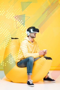 excited man on bean bag chair in virtual reality headset on yellow with cyberspace illustration clipart