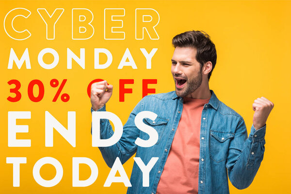 happy handsome man showing yes gesture isolated on yellow with cyber Monday illustration, shopping concept