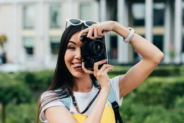 Attractive Asian Woman Glasses Sticking Out Tongue Taking Photo — Stock Photo, Image