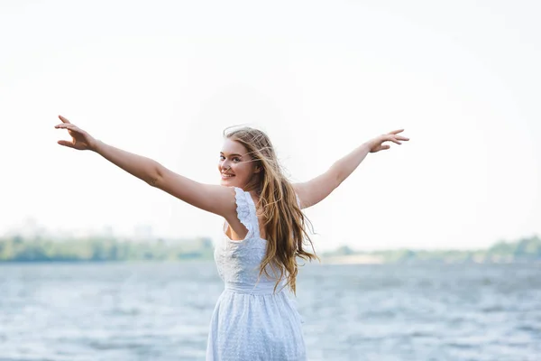 Beautiful Girl White Dress Standing Hands Air Looking Camera — Stock Photo, Image