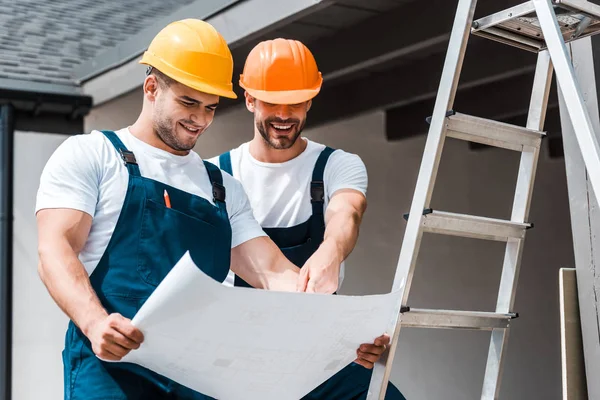Happy Architects Helmets Looking Paper Smiling Ladder — Stock Photo, Image
