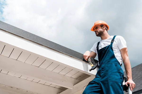 Low Angle View Repairman Helmet Uniform Holding Hammer Standing Blue — Stock Photo, Image