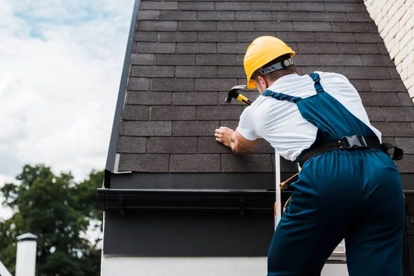 Achteraanzicht Van Klusjesman Uniform Helm Reparatie Dak Terwijl Staande Ladder — Stockfoto