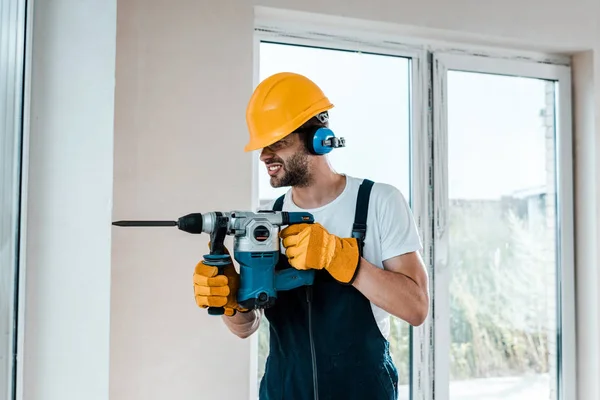Handyman Uniform Yellow Gloves Using Hammer Drill — Stock Photo, Image