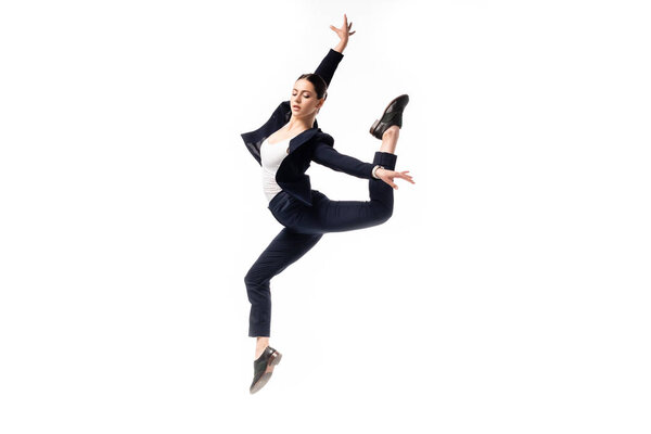 attractive businesswoman in black formal wear dancing isolated on white