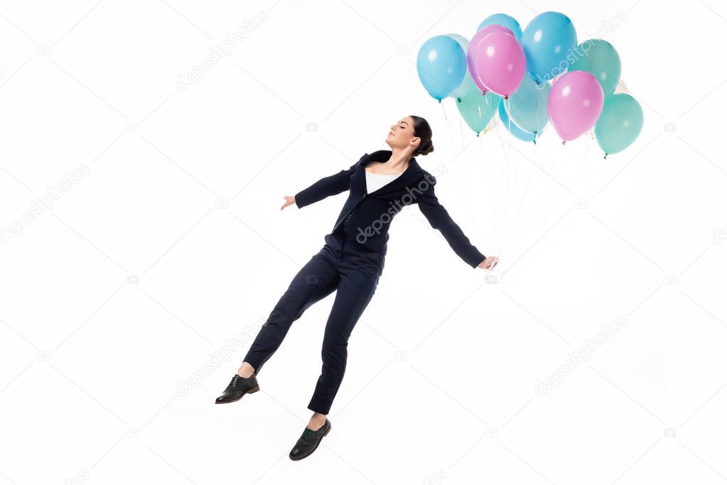 attractive businesswoman in woman levitating with festive balloons isolated on white
