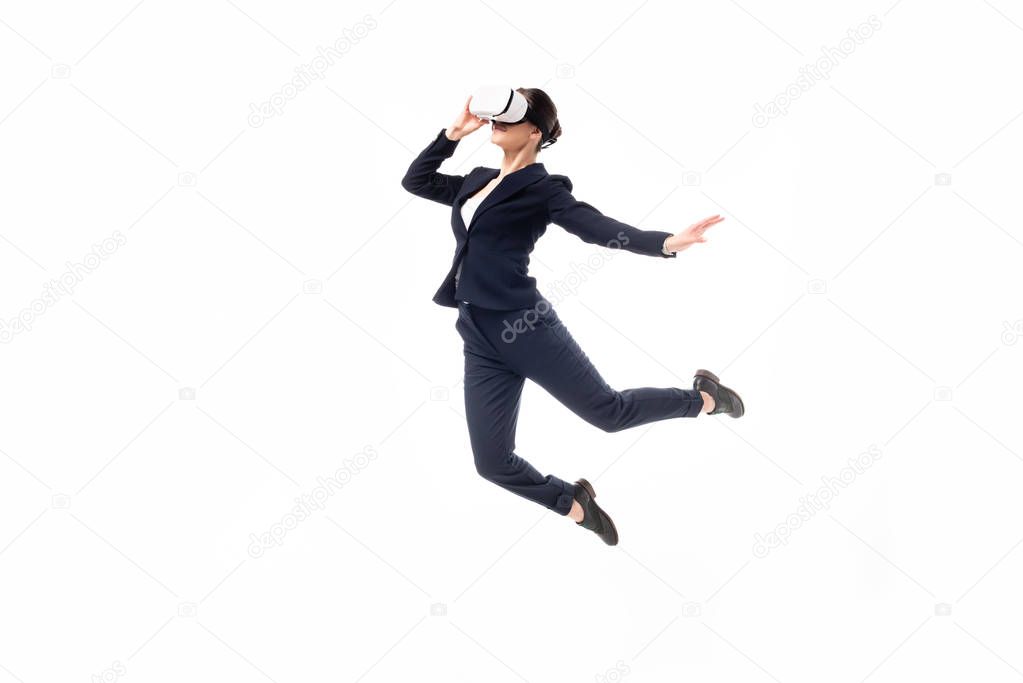 businesswoman in virtual reality headset levitating isolated on white