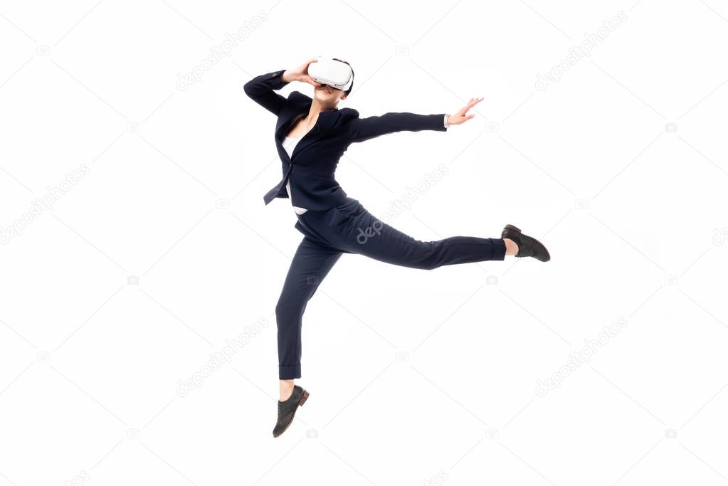 young businesswoman dancing while using virtual reality headset isolated on white