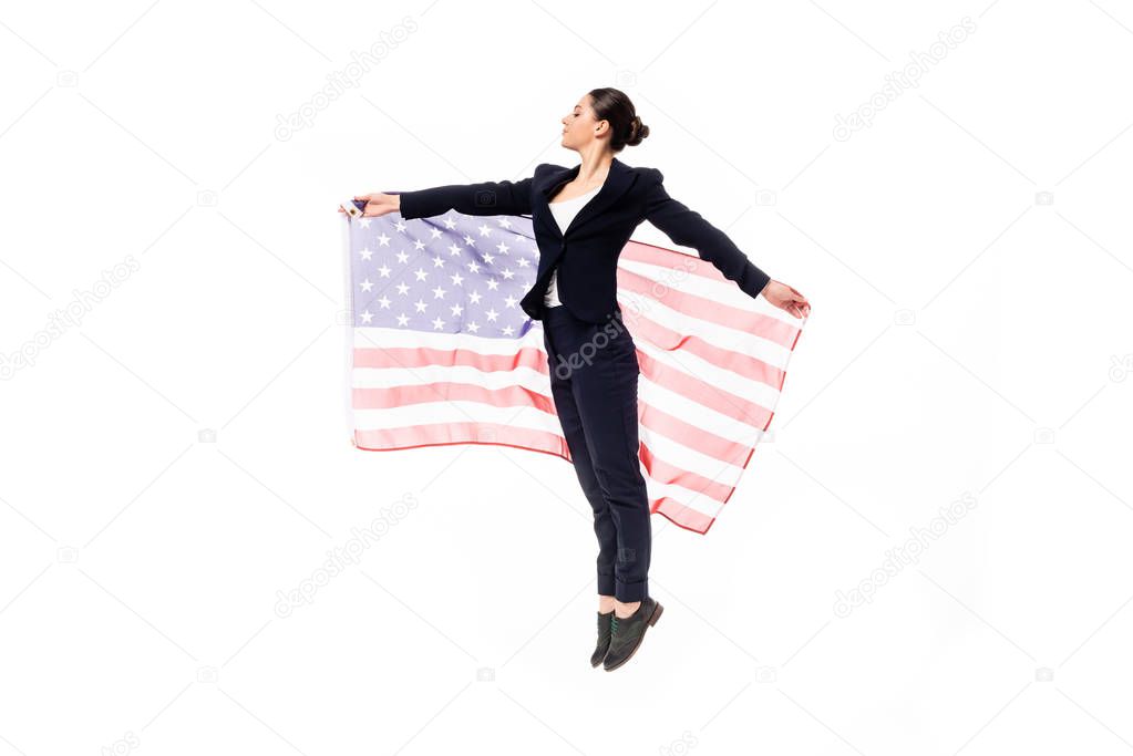 attractive businesswoman dancing while holding united states national flag isolated on white