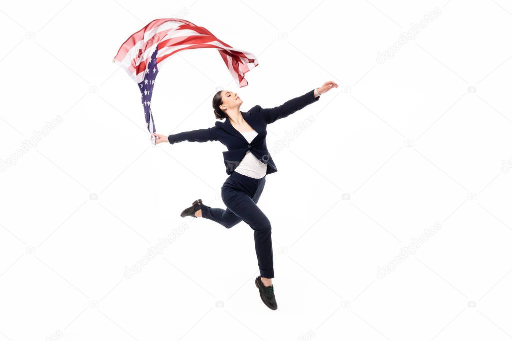 graceful businesswoman in formal wear dancing with united states of america national flag isolated on white