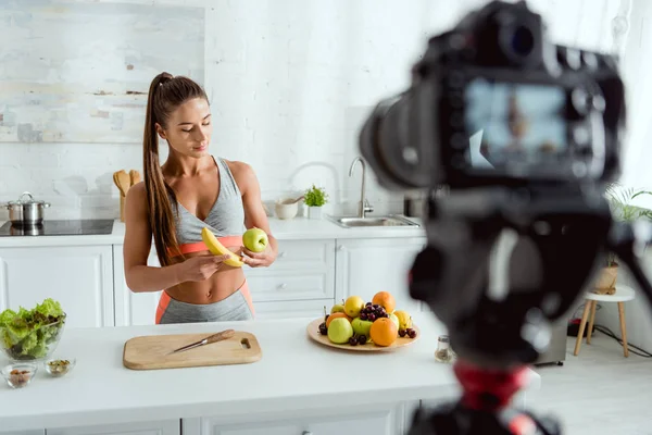 Selective Focus Attractive Athletic Girl Holding Apple Banana Digital Camera — Stock Photo, Image