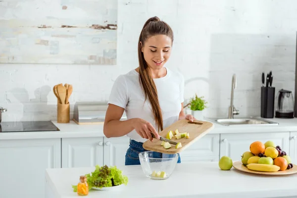 Happy Young Woman Putting Sliced Green Apple Bowl — Stock Photo, Image