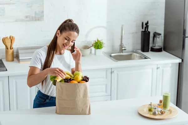 Happy Young Woman Talking Smartphone Paper Bag Fruits — Stock Photo, Image