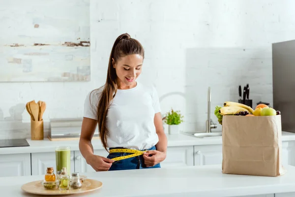 Happy Young Woman Measuring Waist Groceries — Stock Photo, Image