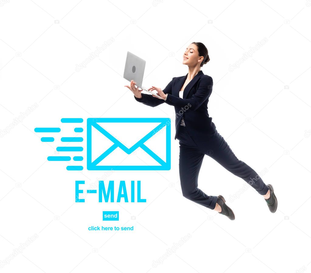 smiling businesswoman levitating while using laptop near e-mail icon and click here to send lettering isolated on white