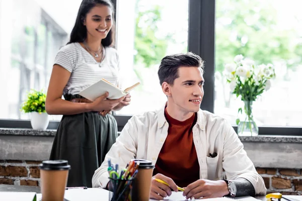 Two Multiethnic Friends Smiling Looking Away Apartment — Stock Photo, Image