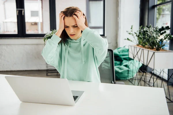 Upset Girl Hoodie Sitting Table Touching Head While Using Laptop — Stock Photo, Image