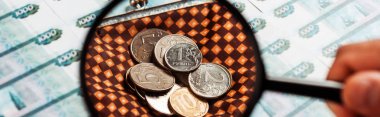 panoramic shot of man holding magnifier near coins in plaid wallet near russian money  clipart