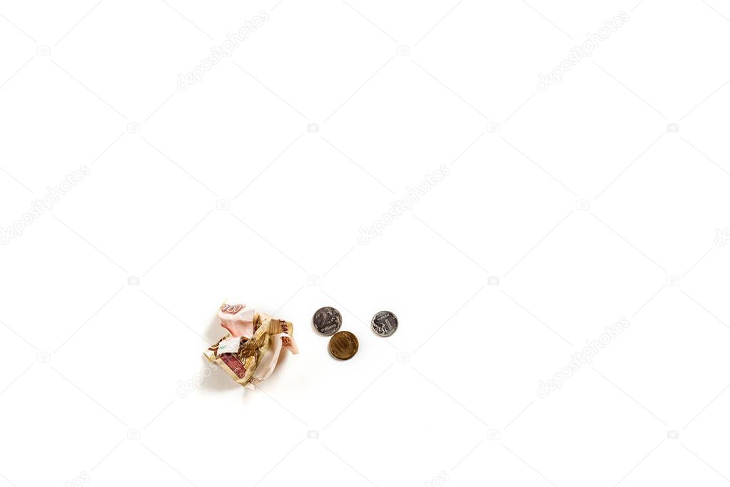 top view of metallic coins near crumpled russian money isolated on white 