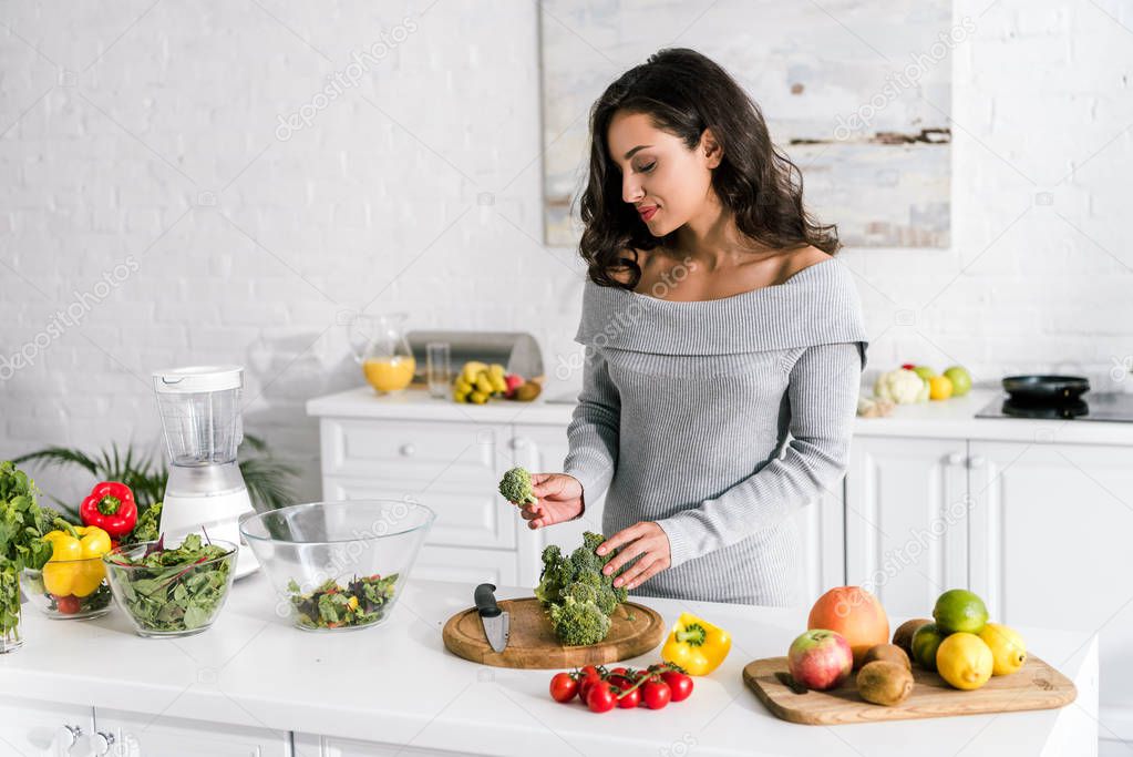 young attractive woman preparing salad at home 