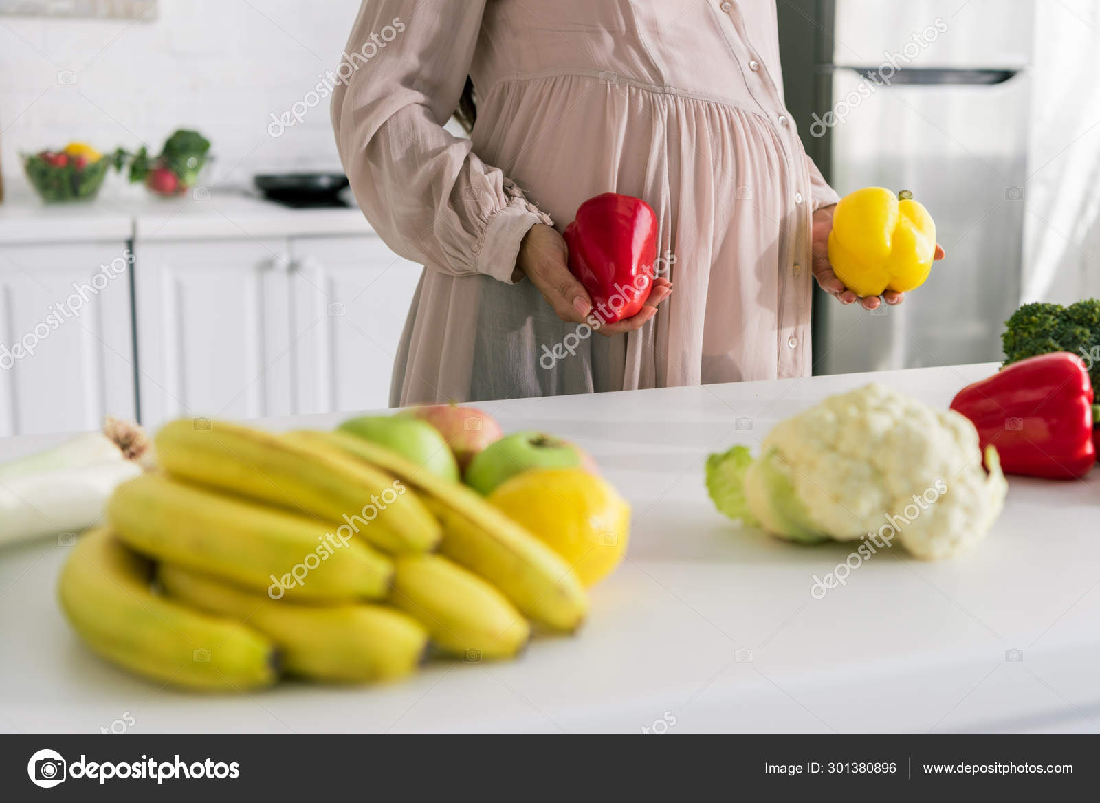 Cropped View Pregnant Woman Holding Paprika Standing Fruits Table Stock
