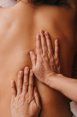 spa kadına sırt masajı yapan masör kırpılmış görünümü 