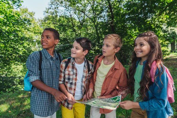 Happy Multicultural Kids Standing Park Holding Map — Stock Photo, Image