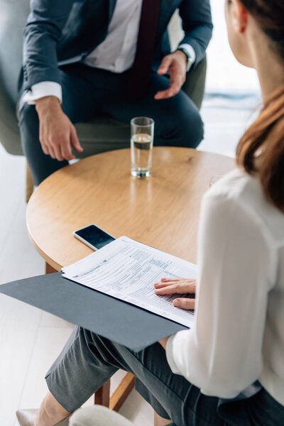 selective focus of businessman in formal and journalist in office 