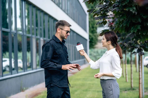 Journalist Som Håller Mikrofonen Och Pratar Med Stilig Polis Uniform — Stockfoto