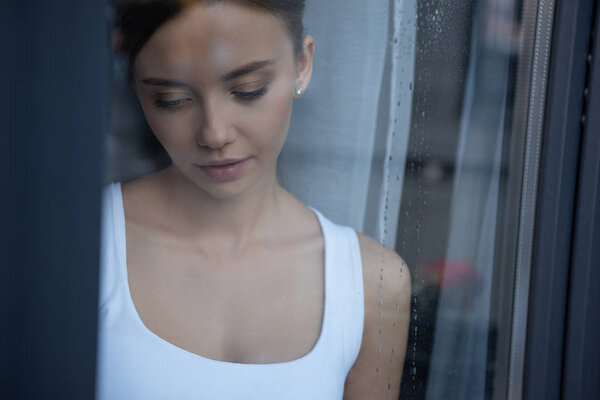 selective focus of sad young woman looking down
