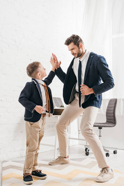 full length view of father and dad in formal wear at home