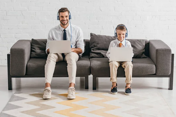 Dad Son Formal Wear Using Laptops Listening Music Headphones While — Stock Photo, Image