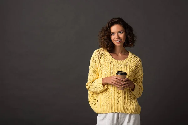 Smiling Curly Woman Yellow Knitted Sweater Holding Coffee Black Background — Stock Photo, Image