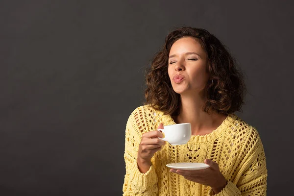 Curly Woman Yellow Knitted Sweater Pouting Lips While Holding Cup — Stock Photo, Image