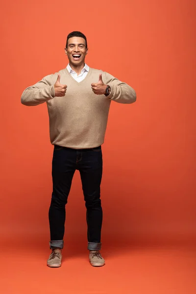 Happy Mixed Race Man Beige Sweater Showing Thumbs Orange — Stock Photo, Image